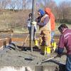 pouring the concrete for the new grain bin foundation